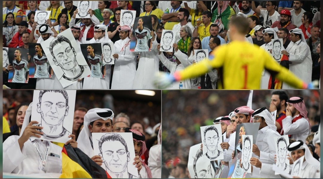 في مباراة اسبانيا والمانيا ..الجماهير العربية تزين المدارج بصور اوزيل  ردا على  "شارةالمثلية" !!